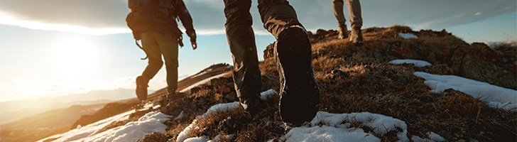 close up of people walking up a snowy hill