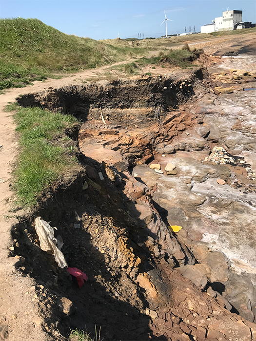 A photo of a coastal landfill site.