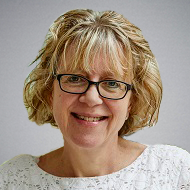 A photo of Professor Liz Price smiling at the camera.