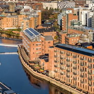 Leeds skyline overlooking the docks with a range of civic, residential, and industrial buildings