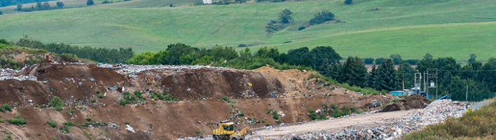 Photograph of landfill site with a digger