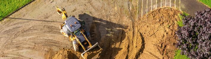 Aerial view of a digger in a field
