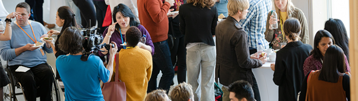 A group of people talking during a conference break