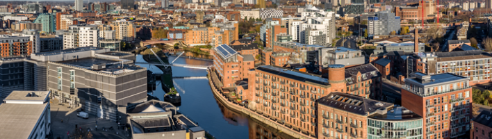 Leeds skyline overlooking the docks with a range of civic, residential, and industrial buildings