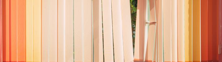 Blinds swaying in front of an open window.