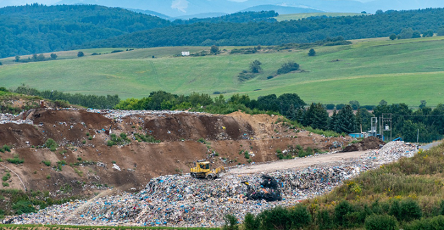 Photograph of landfill site with a digger
