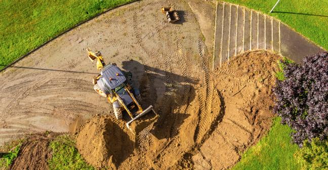 Aerial view of a digger in a field