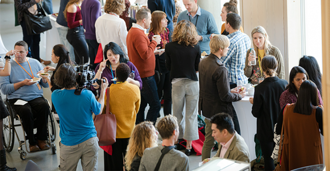 A group of people talking during a conference break