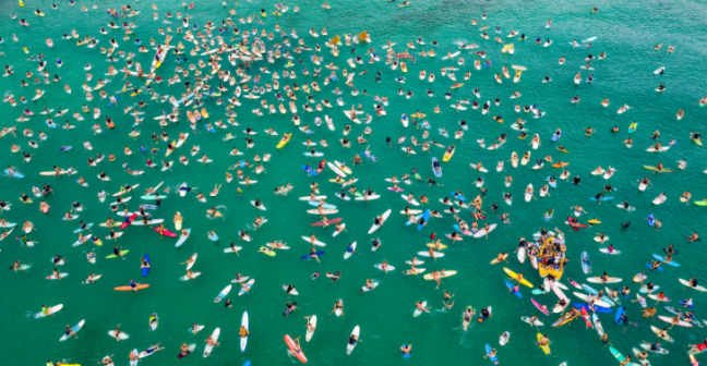 Group of surfers in the ocean pictured from above