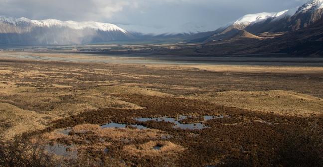 image of grassland with mountains in the distance