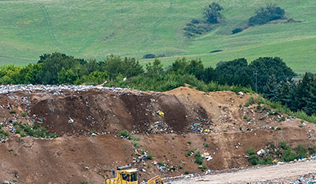 Photograph of landfill site with a digger
