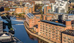 Leeds skyline overlooking the docks with a range of civic, residential, and industrial buildings