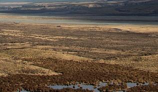 image of grassland with mountains in the distance