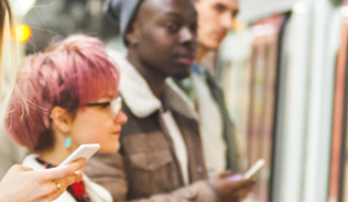People checking social media near a train