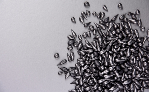 Scattered drops of lead on a plain background