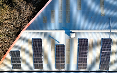 Aerial view of photovoltaic panels on a factory roof © PhotographyBradley via Adobe Stock.jpeg