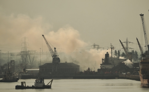 Southampton port, with clouds of smoke rising over it.