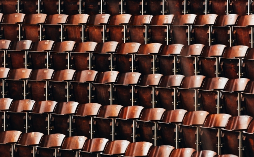 Rows of wooden seats in conference auditorium