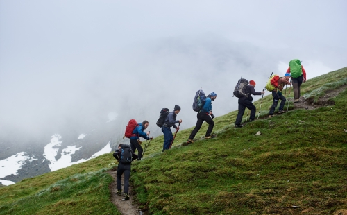 Group of hikers climbing hill