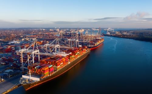 Container ships loading up at a port