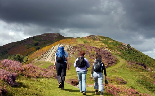 Group hiking up a hill in Conwy, Wales