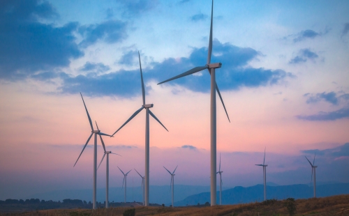 Wind turbines against a sunset sky