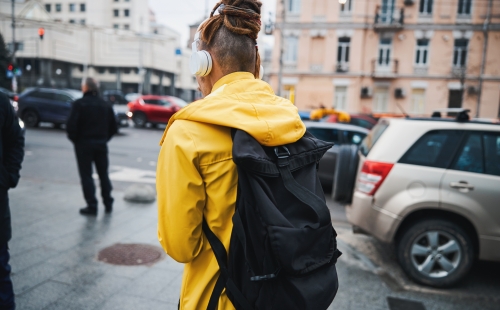 Person walking with headphones in a city