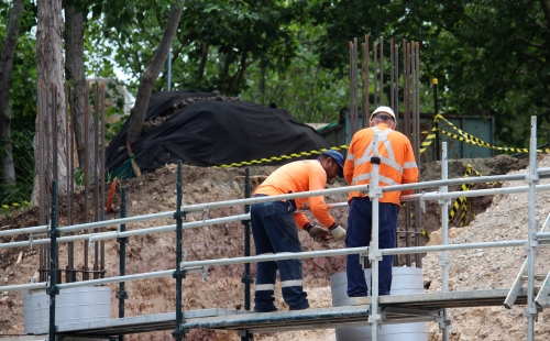 Two men standing on a scaffolding platform