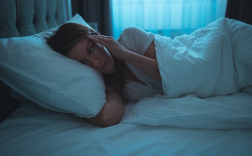Woman in bed experiencing insomnia