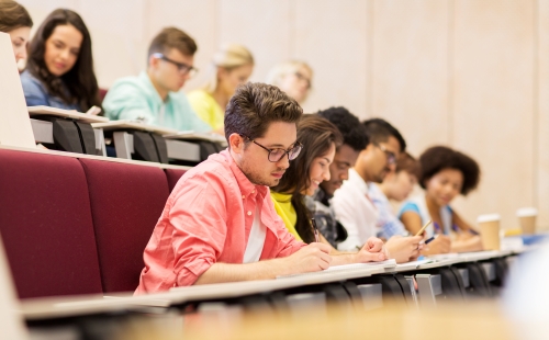 Students taking notes in a lecture hall