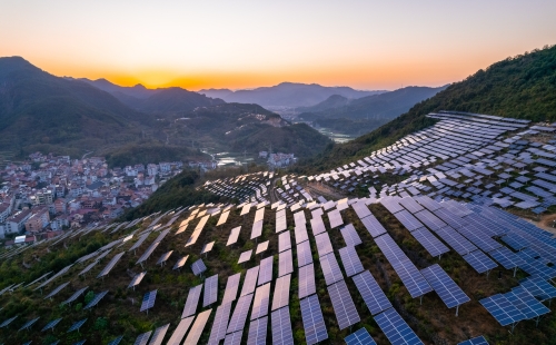 Solar panels on rural hill in China at sunrise