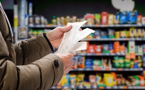 Person examining receipts and thinking about value