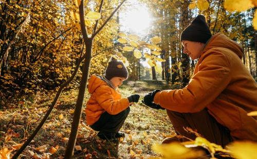 Father and son in autumn forest
