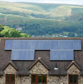 A house retrofitted with solar panels in the middle of a moorland