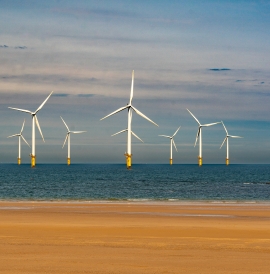 Offshore wind turbines with the beach in the foreground