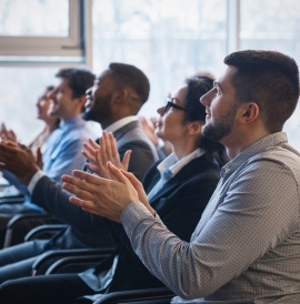 Professionals applauding at a conference