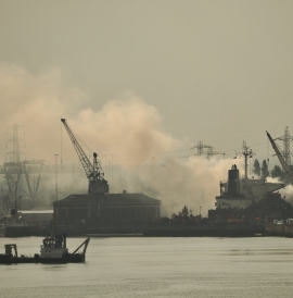 Southampton port, with clouds of smoke rising over it.