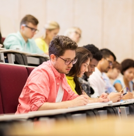 Students taking notes in a lecture hall
