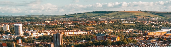 panorama of a city with hills in the background